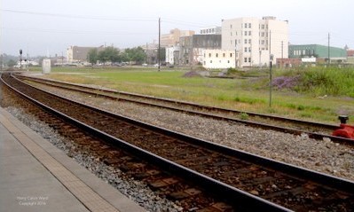 Railroad tracks with downtown buildings in the distance