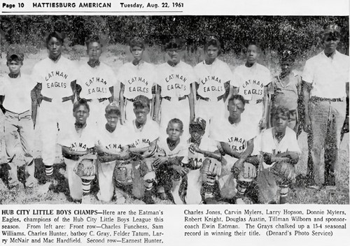 Members of a Little League baseball team pose